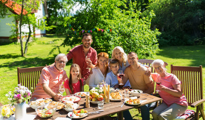 Canvas Print - happy family having dinner or summer garden party