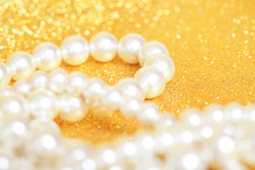 Wall Mural - Pile of pearls on golden christmas background