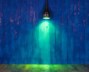 Canvas Print - green light of searchlight on a blue wooden wall