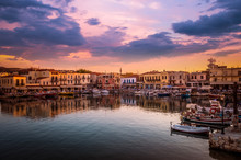 RETHYMNO, CRETE ISLAND, GREECE – JUNE 29, 2016: View Of The Old Venetian Port Of Rethimno At Sunset.
