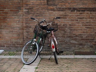  Two bicycles and an old brick wall