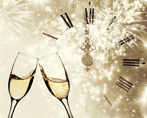 Glasses with champagne and clock close to midnight