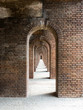 Arched entryways inside old fortress forming an abstract path