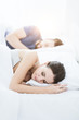 © StockPhotoPro - Couple sleeping in bed