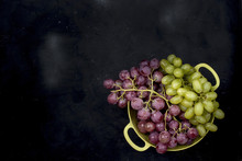 Pink And Green Grapes In A Bowl On A Black Background
