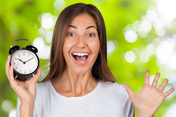 Wall Mural - Smiling woman holding alarm watch