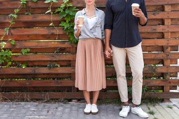 young couple with coffee to go