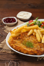 Chicken Schnitzel, Served With Fries And Salad.