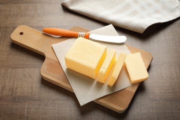 Wall Mural - Cut block of butter on wooden board