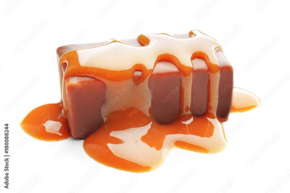 Sweet chocolate candy with caramel topping on white background