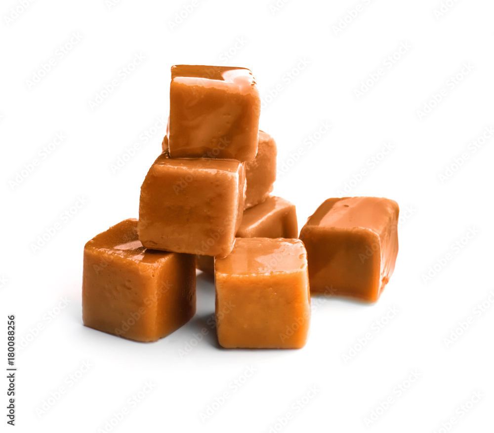 Tasty caramel candies on white background