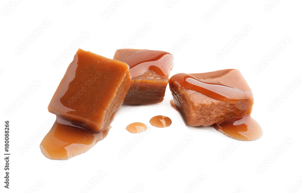 Sweet candies with caramel topping on white background