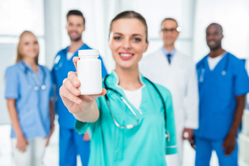 Wall Mural - nurse showing jar of pills