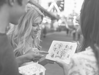 Wall Mural - A group of friends is enjoying the amusement park