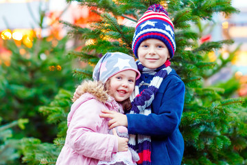 Wall Mural - Two little kids hugging on Christmas market