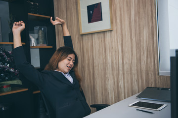 A businesswoman stretch to take a rest from work done during the day.