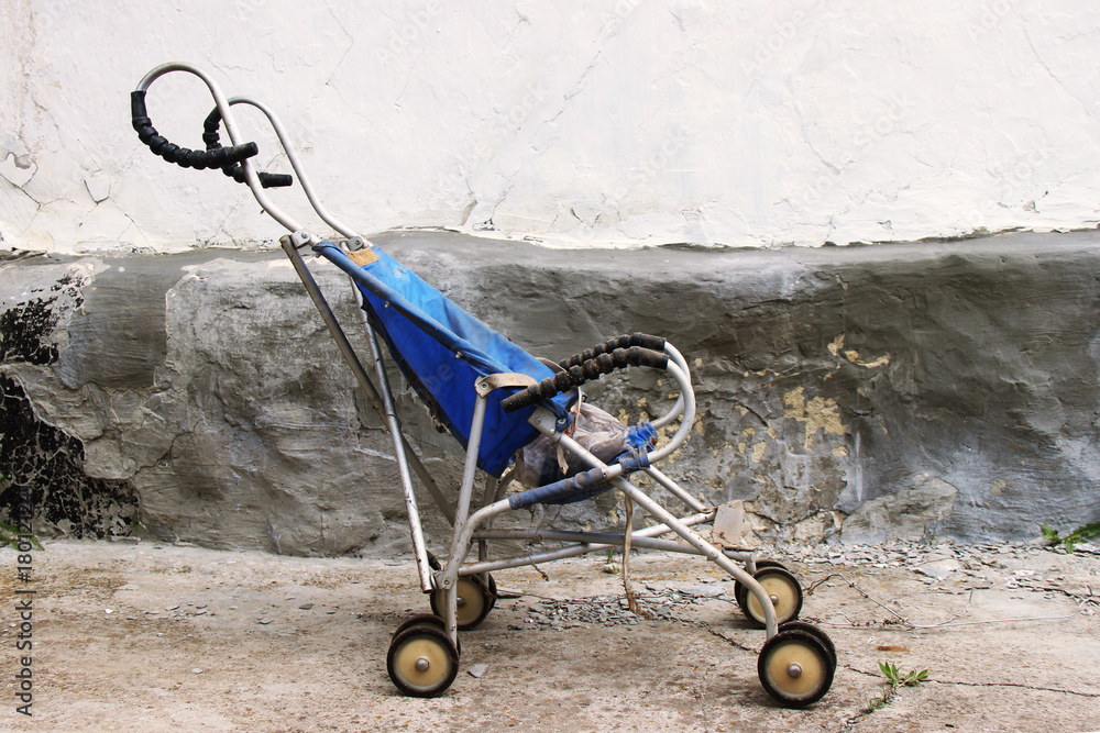 derelict and dis guarded old and dirty vintage pram of pushchair dumped ...