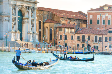 Wall Mural - Grand Canal in Venice with gondolas, tourists and Basilica Santa Maria della Salute in sunny day. Venice, Italy