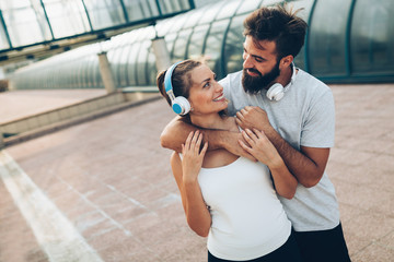 Wall Mural - Portrait of young attractive happy fitness couple