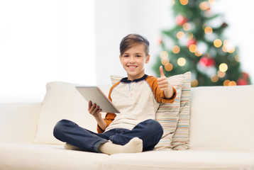 Canvas Print - boy with tablet pc showing thumbs up at christmas