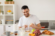 © Syda Productions - man eating toast with coffee at home kitchen