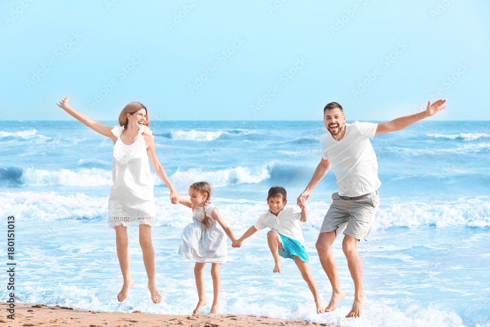 Happy family on sea beach at resort