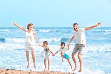 Happy family on sea beach at resort