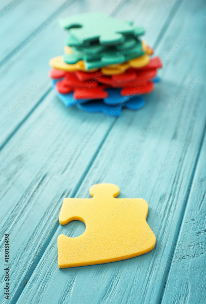 Color puzzles on wooden background