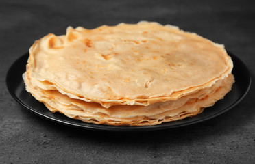 Sticker - Plate with tasty buckwheat thin pancakes on table