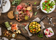 © Iryna Melnyk - Flat lay of delicious dinner table with roasted meat steak, appetizers and desserts. Top view. Healthy food concept.