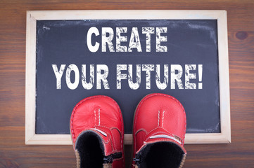 Wall Mural - create your future. kid shoes on on chalkboard and wooden background.