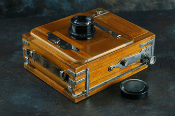 Wall Mural - Vintage wooden camera on a cement background.