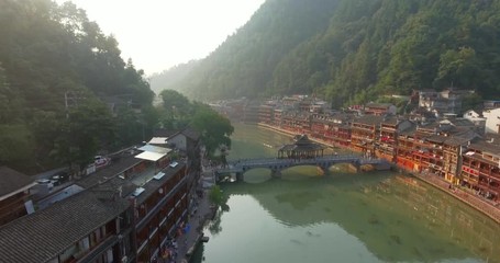 Sticker - Top view or aerial shot of famous ancient town in Fenghuang County, China. Flying over Green River, hills and houses of the village. Travel,destination and world heritage concept.