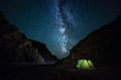 night rocky ravine, starry sky with bright milky way. a little camping