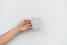 White Coffee Cup In Hand On White Background