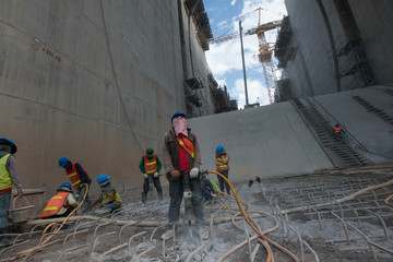 Constrution Workers at Heavy Construction Site, Building Dams, Xayaburri Dam, Xayaburi, Laos	