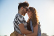 © innervisionpro - Young happy man embracing his girlfriend outside