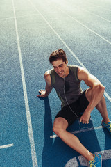 Wall Mural - sprinter relaxing on running track