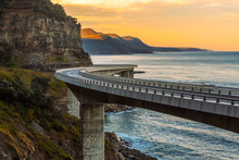 Sunset Over The Sea Cliff Bridge Along Australian Pacific Ocean 