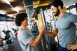 © NDABCREATIVITY - Two young men meeting at gym and giving each other handshake