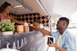 © Syda Productions - african american man buying wok at food truck