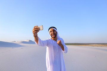 Wall Mural - Portrait of Arabian sheikh man with gadget that communicates in 