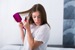 © Tinatin - Woman with a hot straightening brush