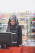 © Odua Images - muslim female shopkeeper or cashier welcoming customer