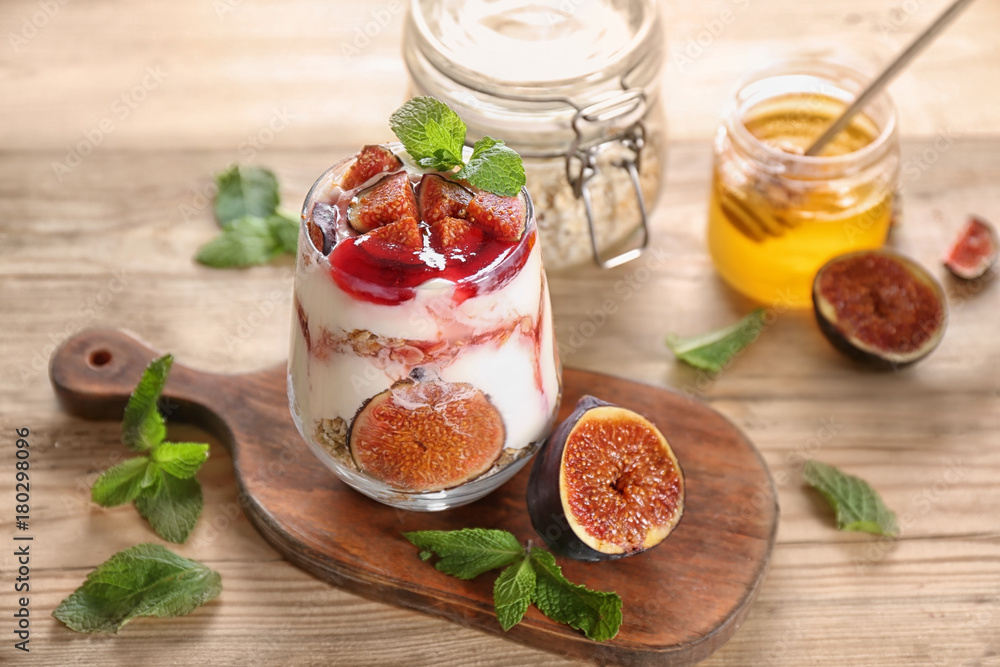 Oatmeal dessert with yogurt and fig in glass on table