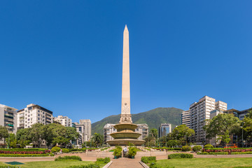 Wall Mural - Panoramic view of Altamira's Obelisk on a sunny day with blue skies in Francia Square (A.k.a. Plaza Altamira), in venezuelan capital city Caracas, in 2017.