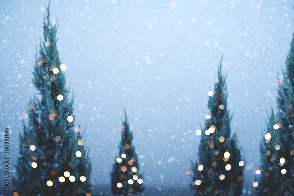 Blurred of Christmas tree and light bokeh with snowfall on sky ...