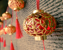 Little Red Lanterns With Chinese Characters "good Fortune" Hanging On Wall. Selective Focus. Toned Image.