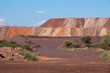 Mining dump with colorful layers of soil excavated from iron ore mining operations.