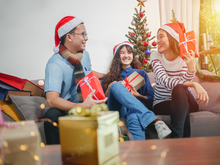 Beautiful Asian friends meeting party for Christmas or New Year, Santa caps on Christmas eve.